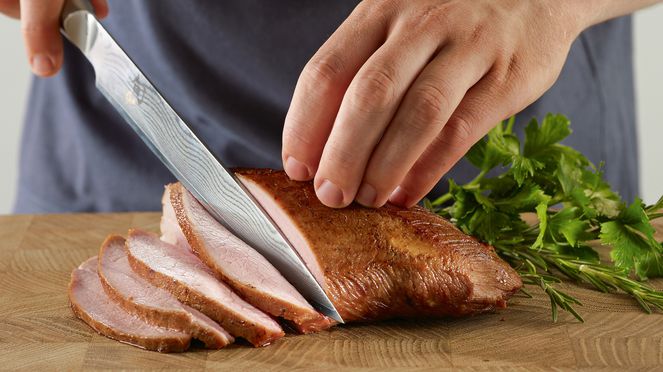 
                    Slicing knife cutting roast