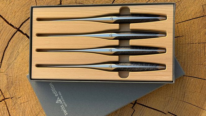 
                    The dark, shimmering handles of the Spirit of the Alps knife set with elegant mother-of-pearl effect